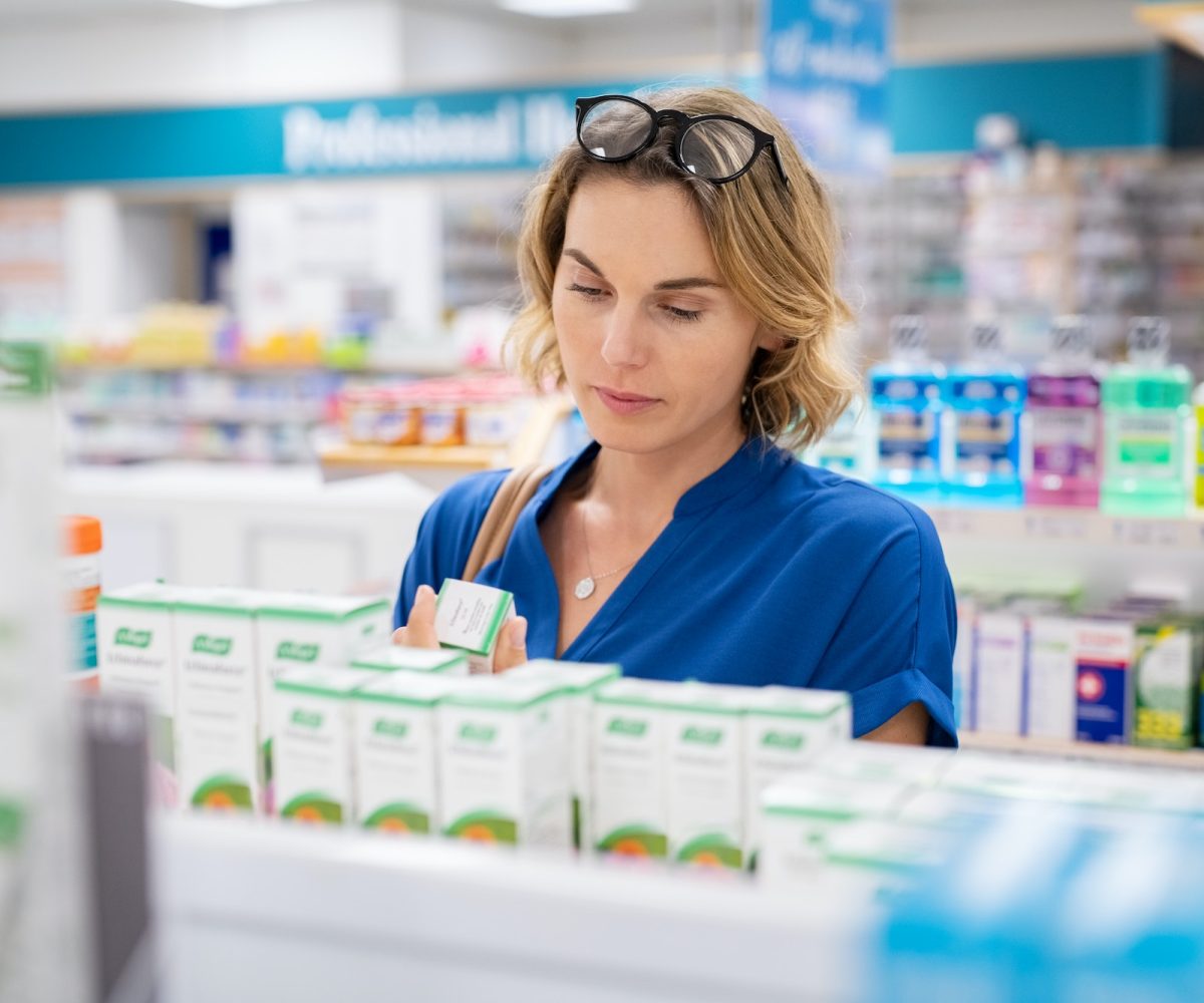 Woman choosing product in pharmacy
